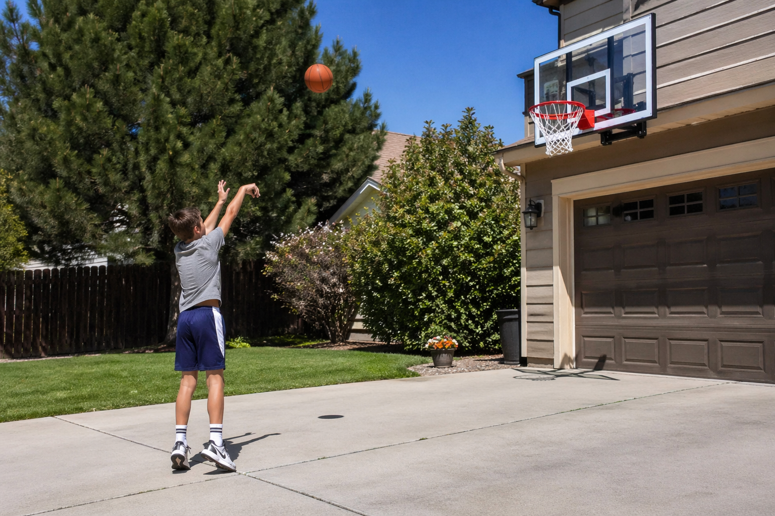 kid shooting a basketball at a driveway hoop
